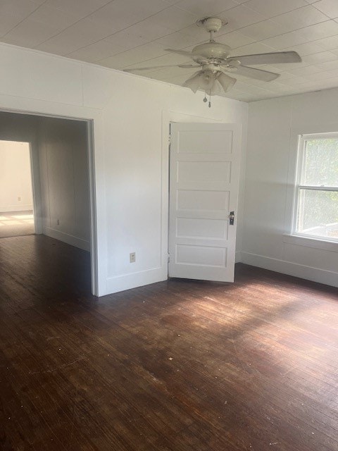 unfurnished room with ceiling fan and dark hardwood / wood-style floors