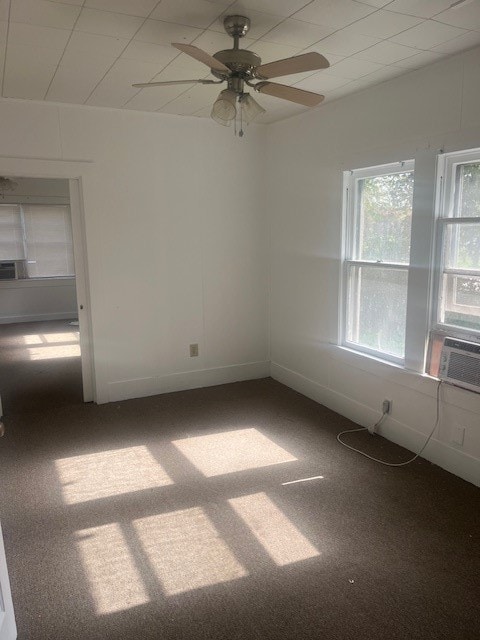 unfurnished room featuring cooling unit, carpet flooring, and ceiling fan