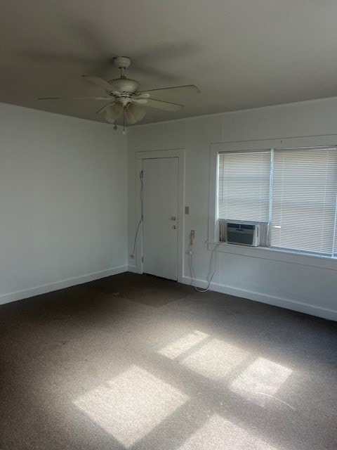 carpeted spare room featuring cooling unit and ceiling fan