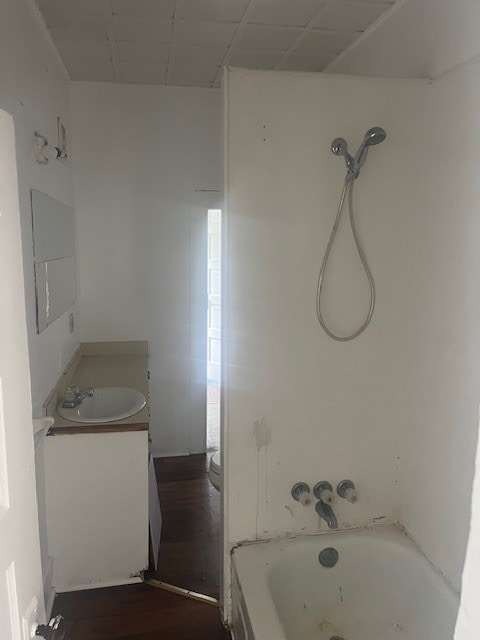 bathroom featuring vanity, hardwood / wood-style flooring, and shower / bathtub combination