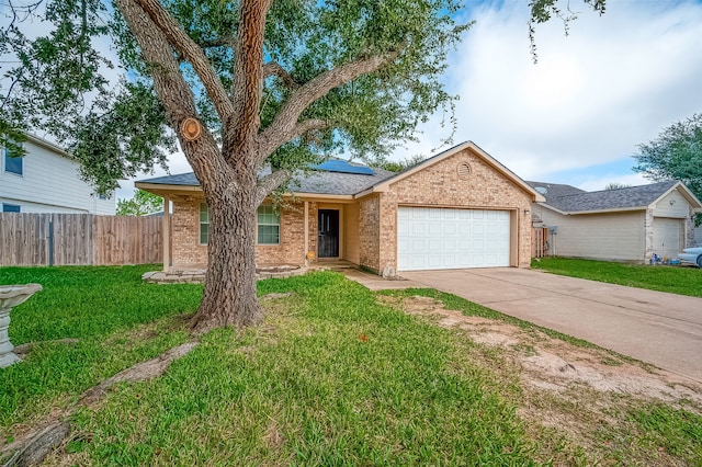 ranch-style home featuring a garage and a front lawn