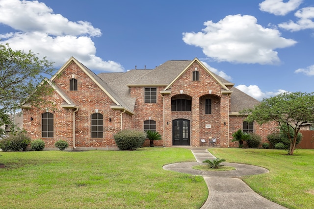 view of front of property with french doors and a front lawn