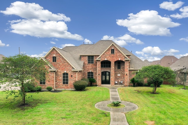 view of front of property featuring a front lawn and french doors