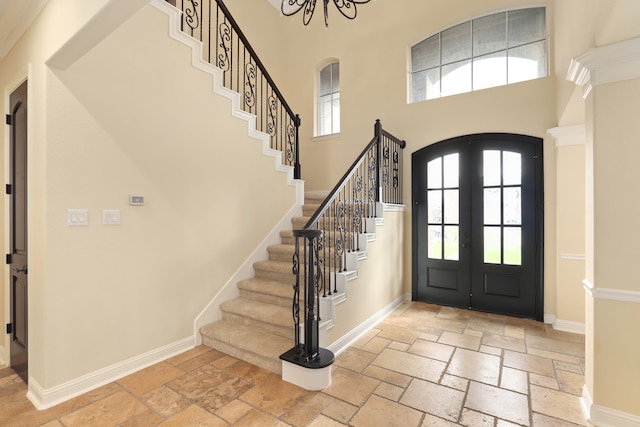 entryway with french doors and a towering ceiling