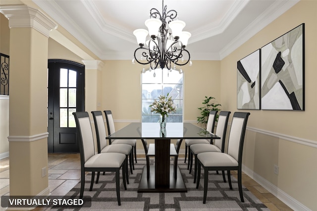 dining room featuring decorative columns, crown molding, and plenty of natural light