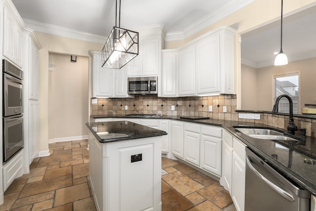 kitchen featuring white cabinets, appliances with stainless steel finishes, hanging light fixtures, and sink