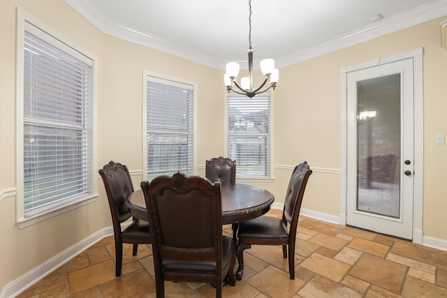 dining room with ornamental molding and a notable chandelier