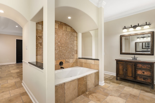 bathroom featuring vanity, tiled bath, and ornamental molding