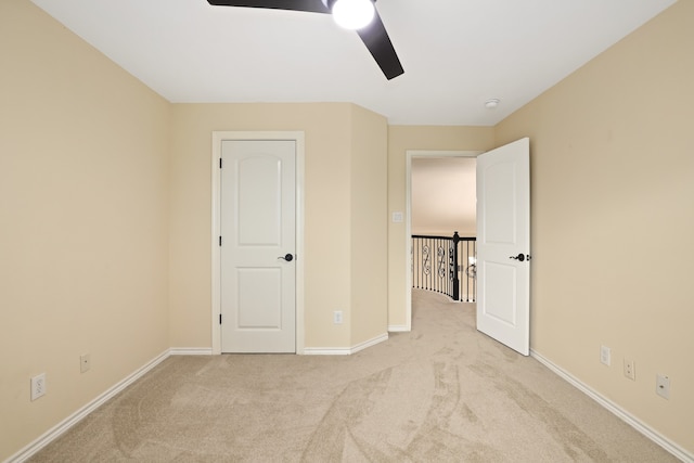 unfurnished bedroom with light carpet and ceiling fan