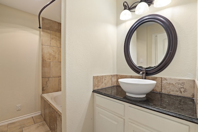 bathroom featuring a tub to relax in and vanity