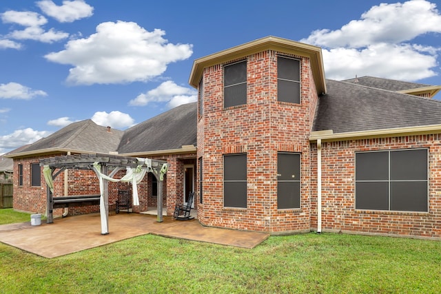 rear view of house with a lawn, a pergola, and a patio