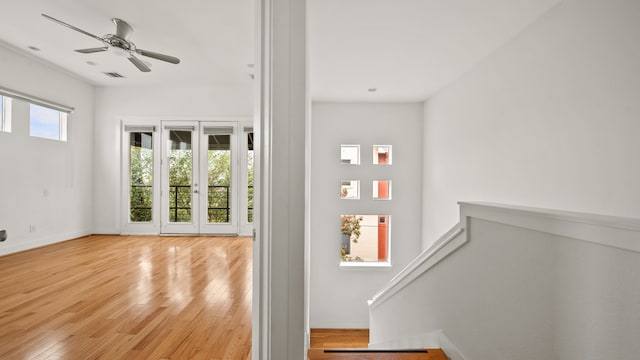 doorway with light hardwood / wood-style floors and ceiling fan