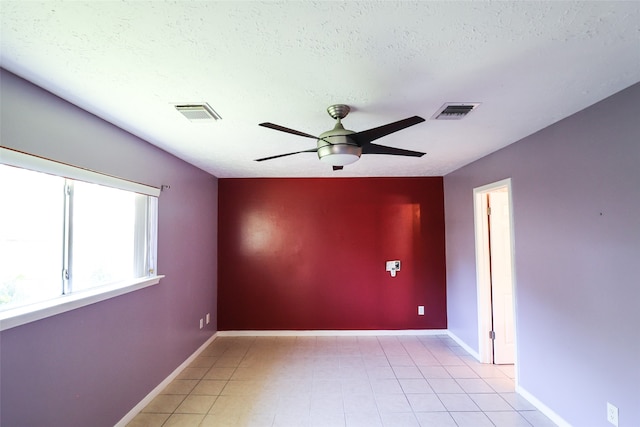 spare room with ceiling fan and a textured ceiling