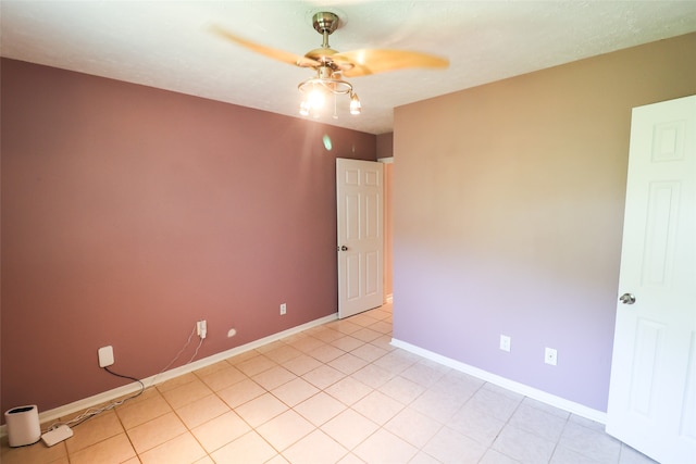 tiled spare room featuring ceiling fan