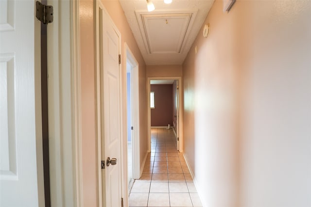 hall with light tile patterned floors