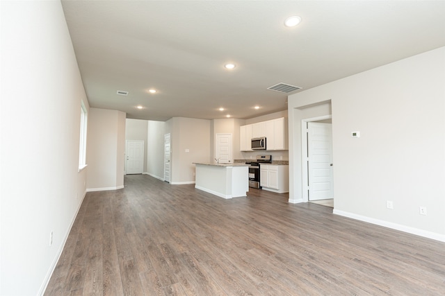 unfurnished living room featuring hardwood / wood-style flooring