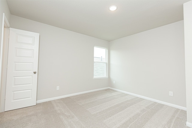 unfurnished room with light colored carpet