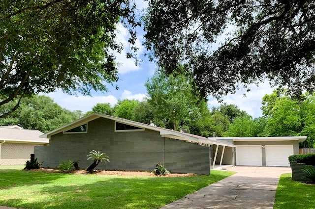 single story home with a front yard and a garage