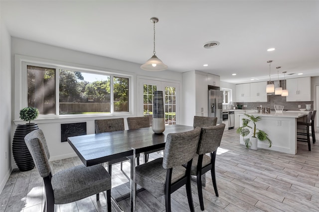 dining area featuring light hardwood / wood-style flooring and sink