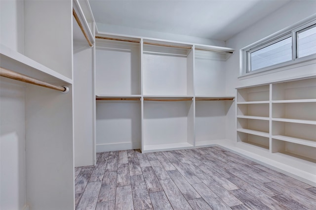 walk in closet featuring light hardwood / wood-style flooring