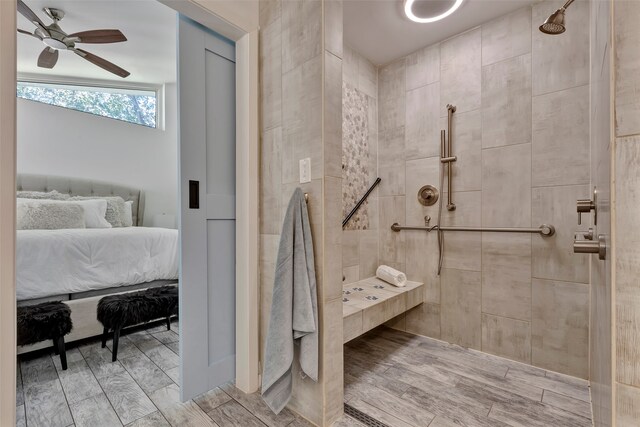 bathroom with ceiling fan and tiled shower