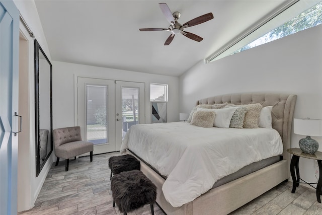 bedroom with lofted ceiling, ceiling fan, light wood-type flooring, and multiple windows