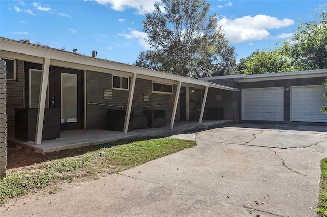 rear view of house with a garage