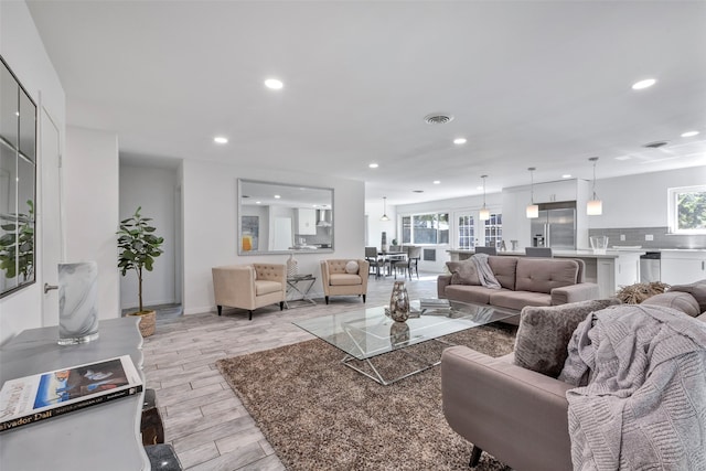 living room with light wood-type flooring and a wealth of natural light