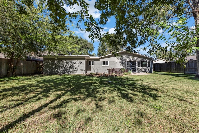 rear view of house featuring a lawn