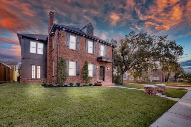 colonial home with a lawn