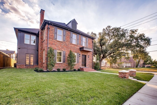 colonial-style house with a front lawn