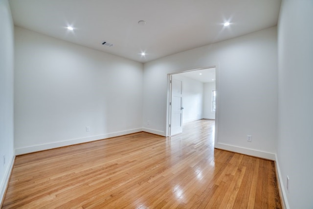 spare room featuring light hardwood / wood-style flooring