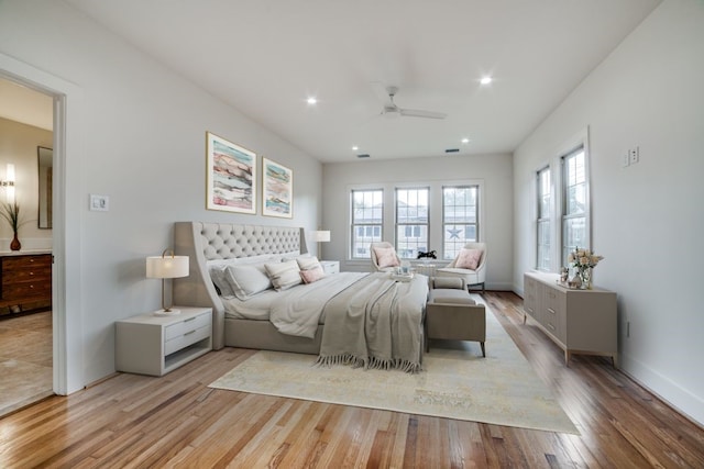 bedroom with light hardwood / wood-style flooring and ceiling fan