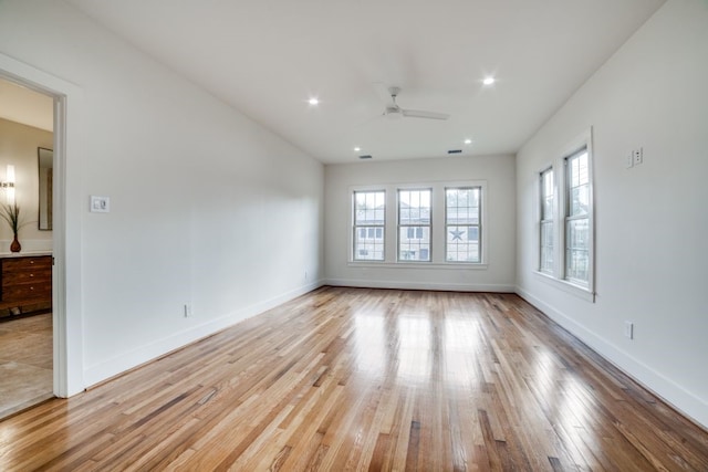 spare room with light wood-type flooring and ceiling fan