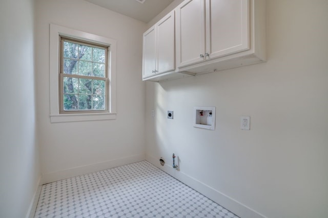 laundry area featuring hookup for an electric dryer, cabinets, hookup for a washing machine, and hookup for a gas dryer