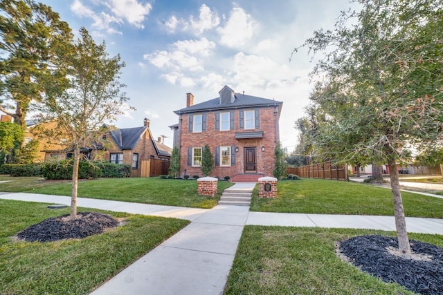 colonial-style house with a front yard