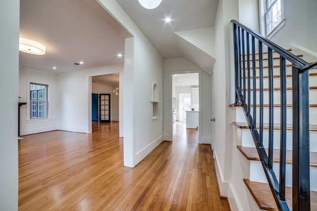 entrance foyer featuring a notable chandelier and light hardwood / wood-style floors