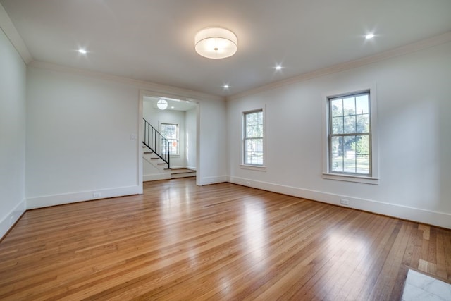 unfurnished room with ornamental molding and light hardwood / wood-style floors