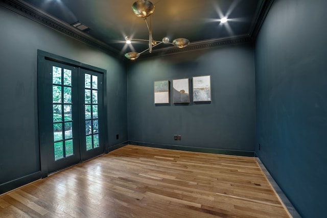 unfurnished room with hardwood / wood-style floors, french doors, and ornamental molding