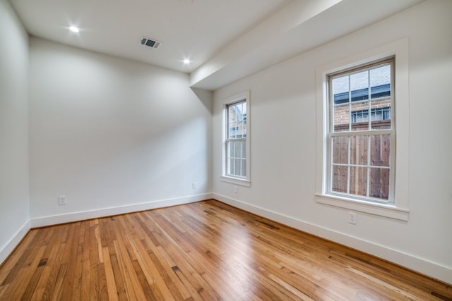 unfurnished room with light wood-type flooring and plenty of natural light