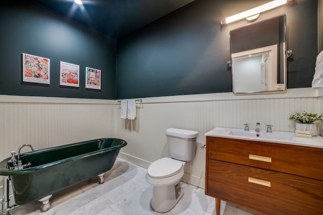 bathroom featuring toilet, a tub to relax in, and vanity