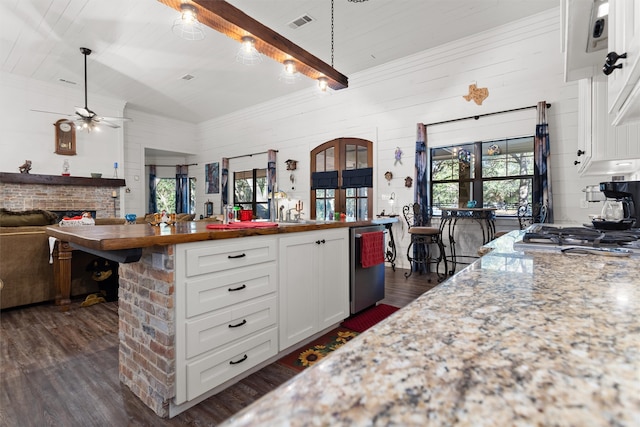 kitchen featuring wooden counters, white cabinets, dark hardwood / wood-style flooring, and pendant lighting