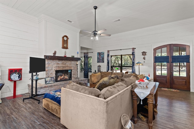 living room with ceiling fan, a fireplace, dark wood-type flooring, and french doors