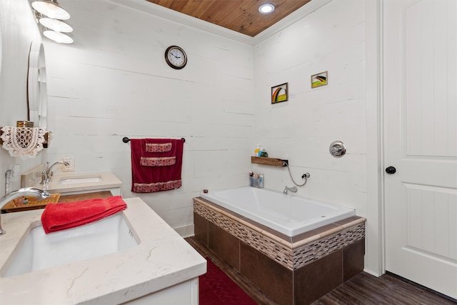 bathroom featuring vanity, wooden ceiling, wood-type flooring, and a bath