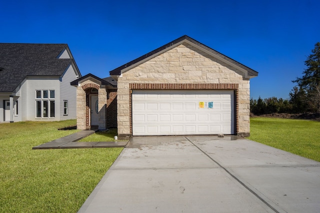 view of front of house featuring a garage and a front lawn