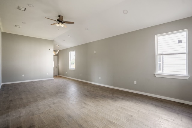 unfurnished room with vaulted ceiling, ceiling fan, and wood-type flooring