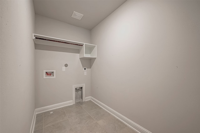 washroom with hookup for an electric dryer, washer hookup, light tile patterned floors, and gas dryer hookup