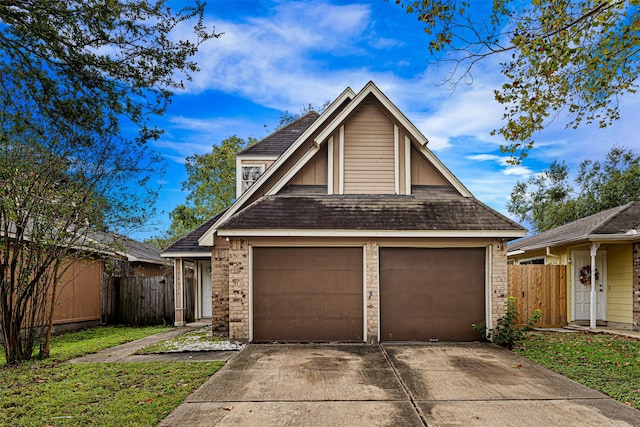 view of front of house featuring a garage and a front yard