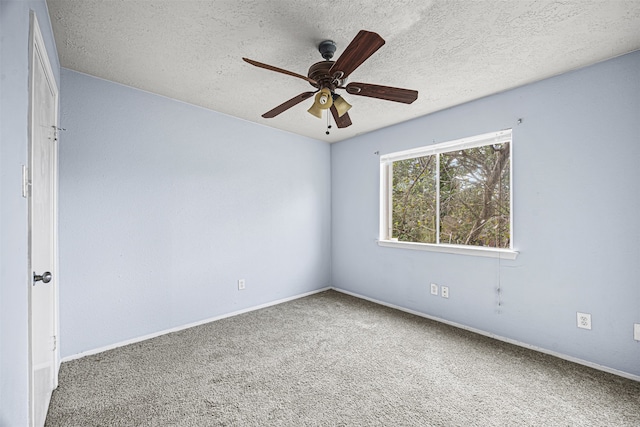 spare room featuring a textured ceiling, ceiling fan, and carpet floors