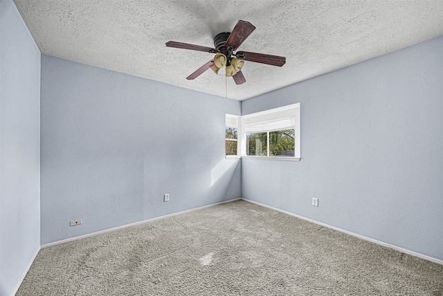 carpeted empty room featuring a textured ceiling and ceiling fan